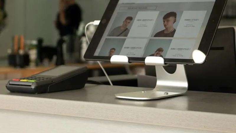 Check-in tablet and card terminal on a reception counter